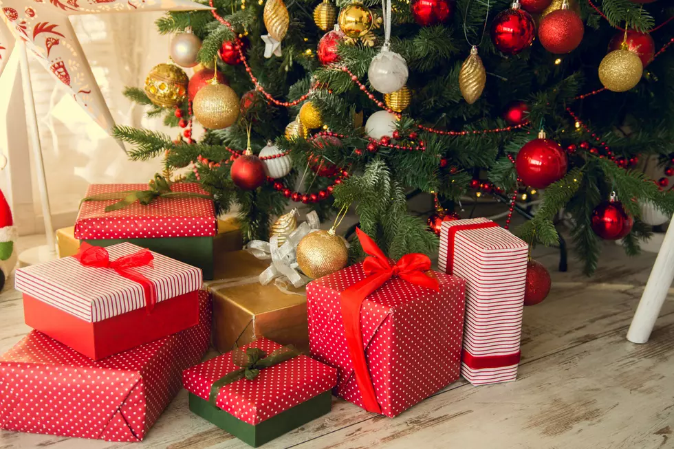 Gifts under a Christmas under spruce on the wooden floor